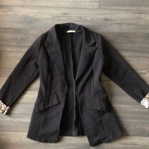Black blazer with leopard print cuffs.